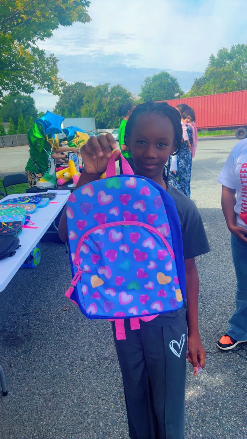 Child receiving backpack