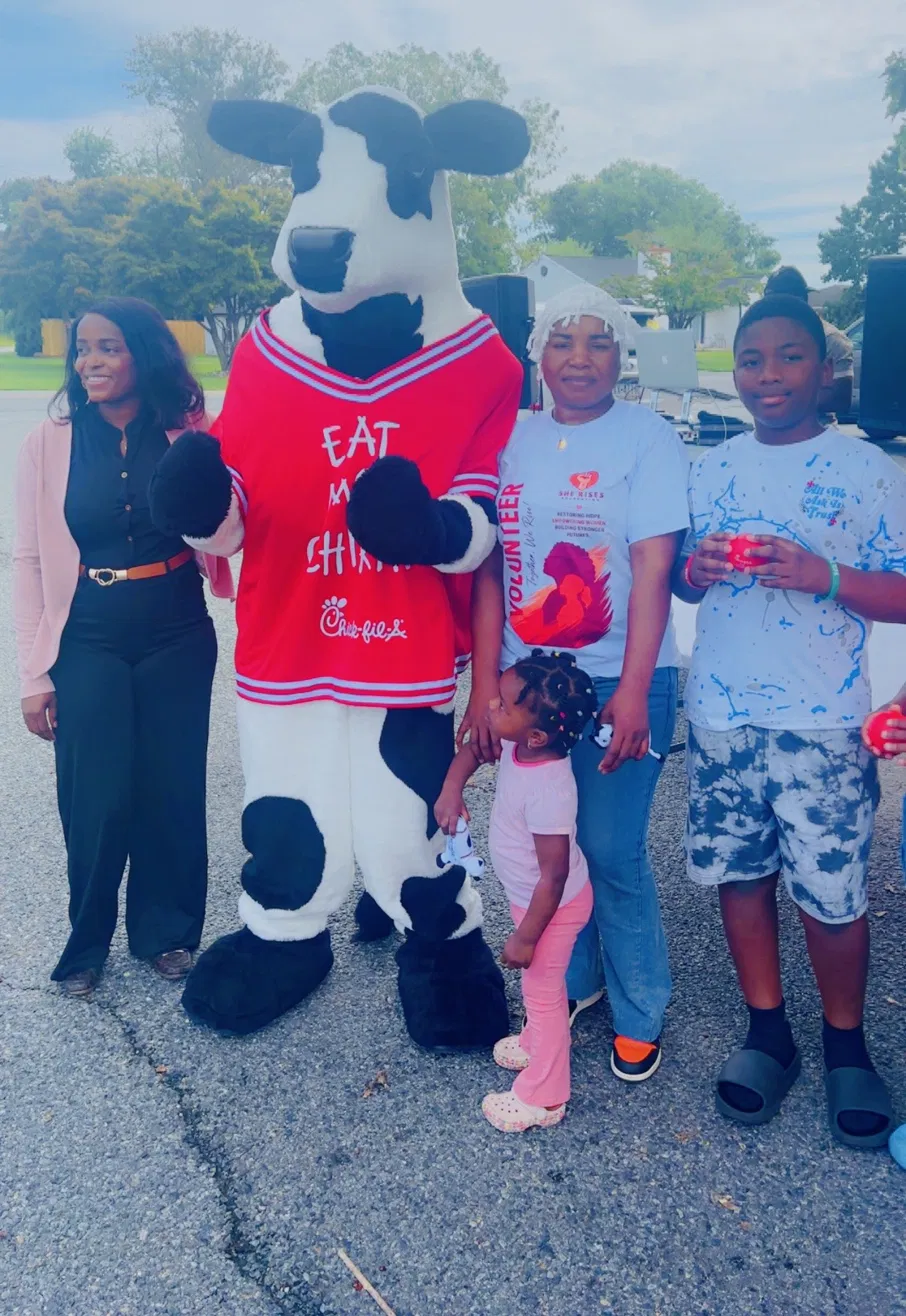 Chick-fil-A cow mascot with volunteer