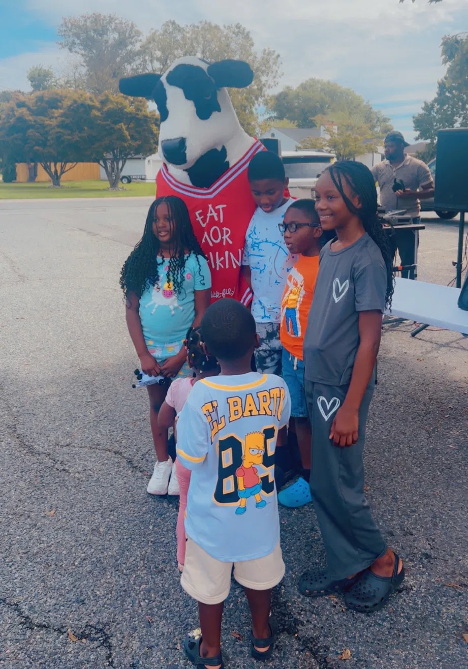Community members with mascot