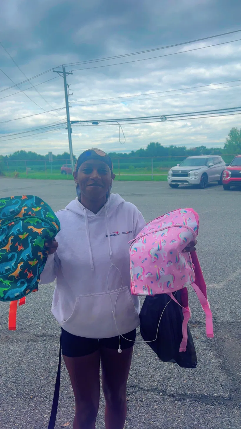 Volunteer distributing backpacks