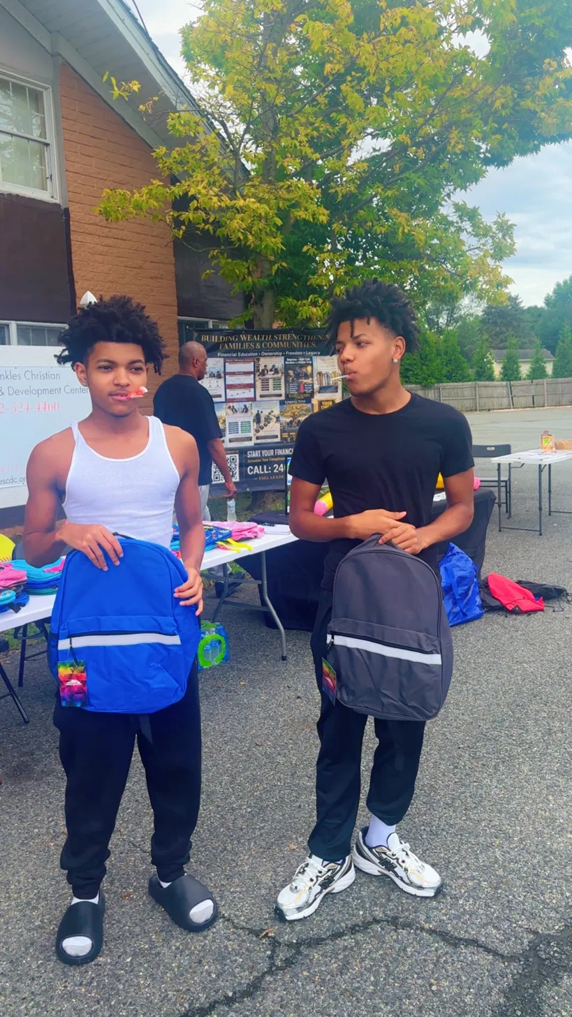 Volunteers distributing backpacks